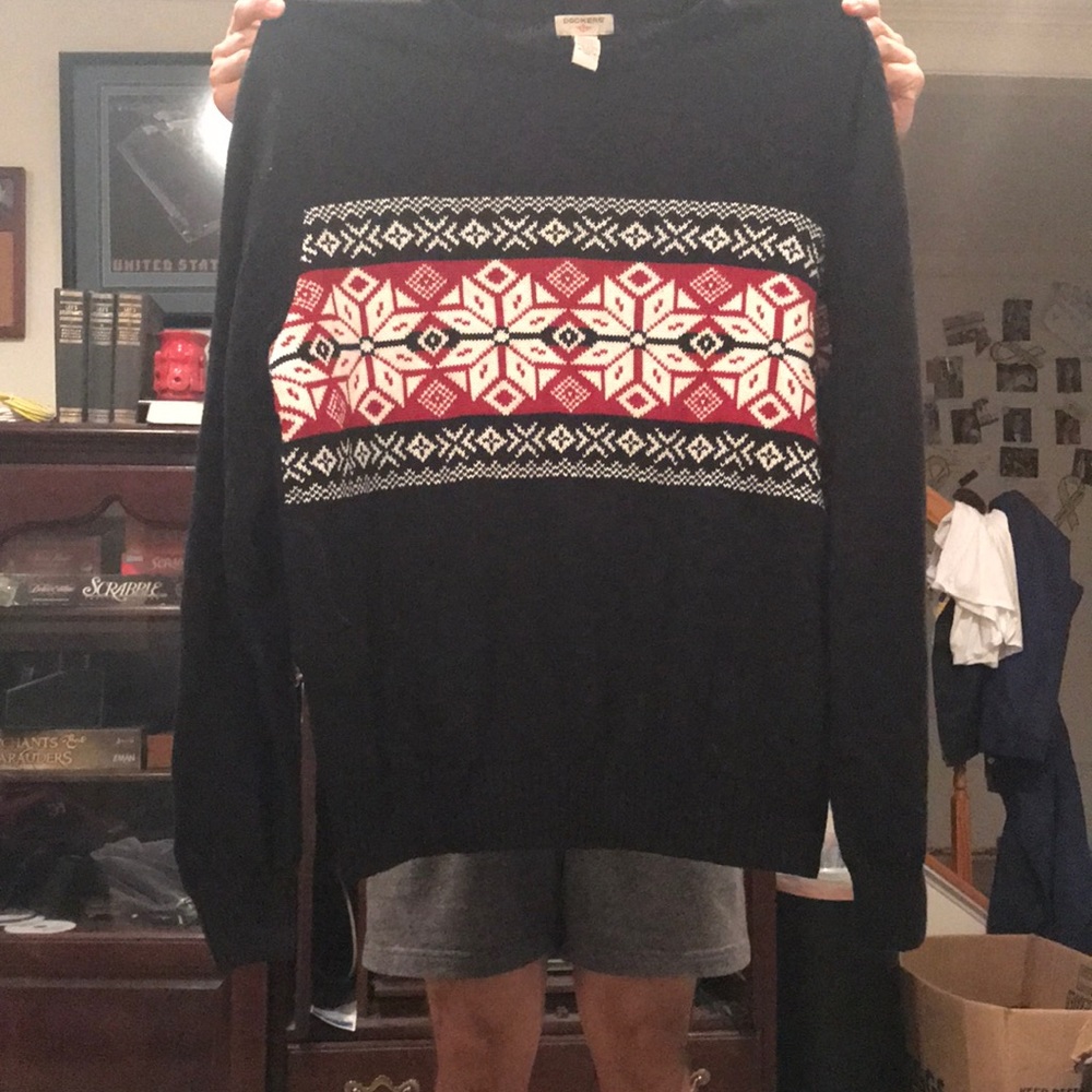 Black, white, red sweater. Size large. Never worn